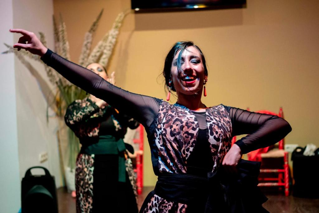 two women dancing in a room with their arms out at Ona Alanda Club Marbella in Marbella
