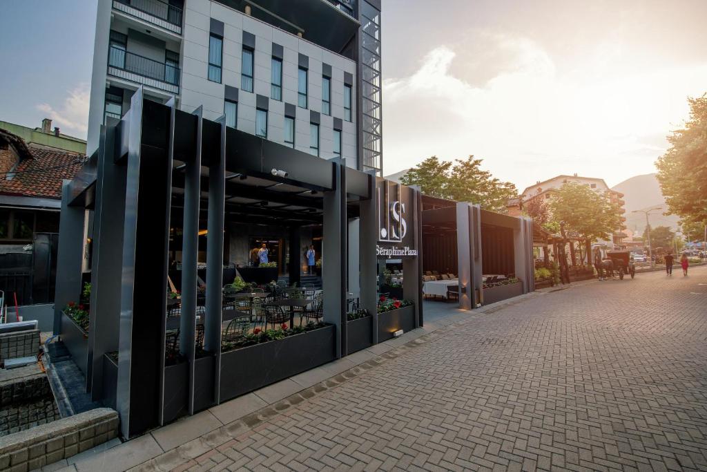 a store front of a building on a street at Seraphine Plaza in Peje