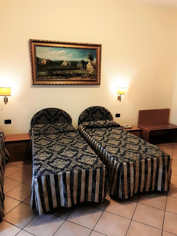 Postel nebo postele na pokoji v ubytování Hotel Mariano