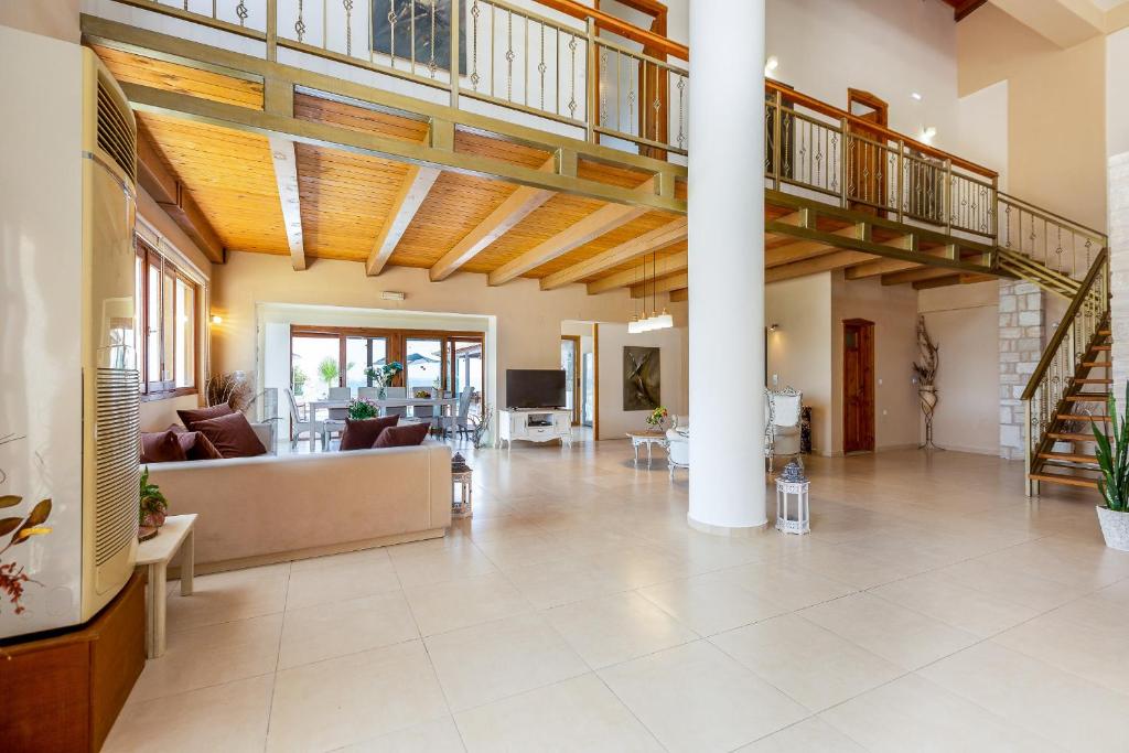 duży salon ze sklepionym sufitem w obiekcie Golden Sand Beach Villa w mieście Magnisía
