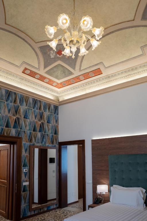 Postel nebo postele na pokoji v ubytování Palazzo Scamozzi