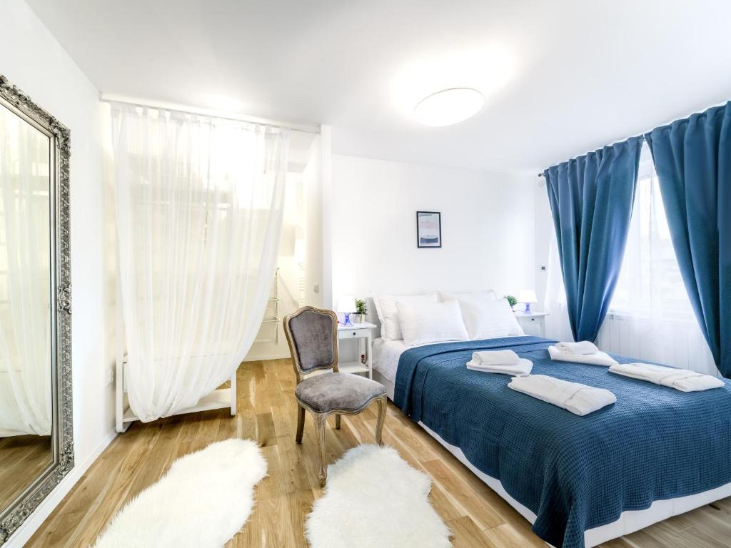 um quarto com uma cama, uma cadeira e um espelho em Superior Central Stay em Zagreb