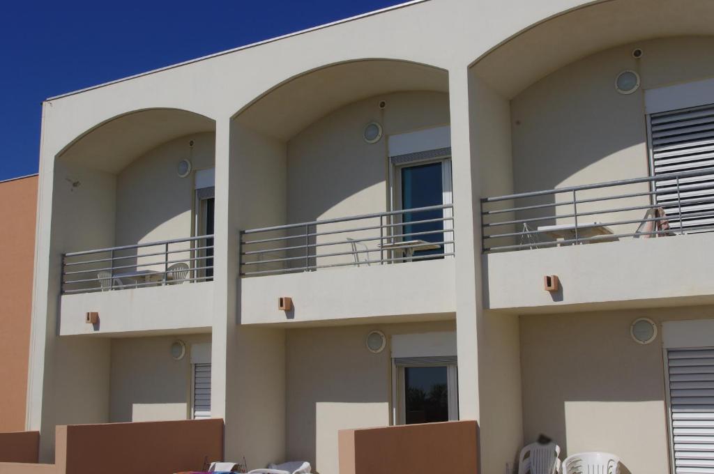 a building with balconies on the side of it at Les Stoechades in Hyères
