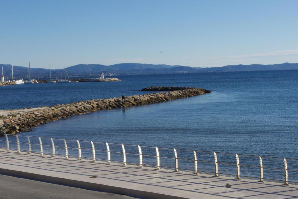 a body of water with a fence next to it at Les Stoechades in Hyères