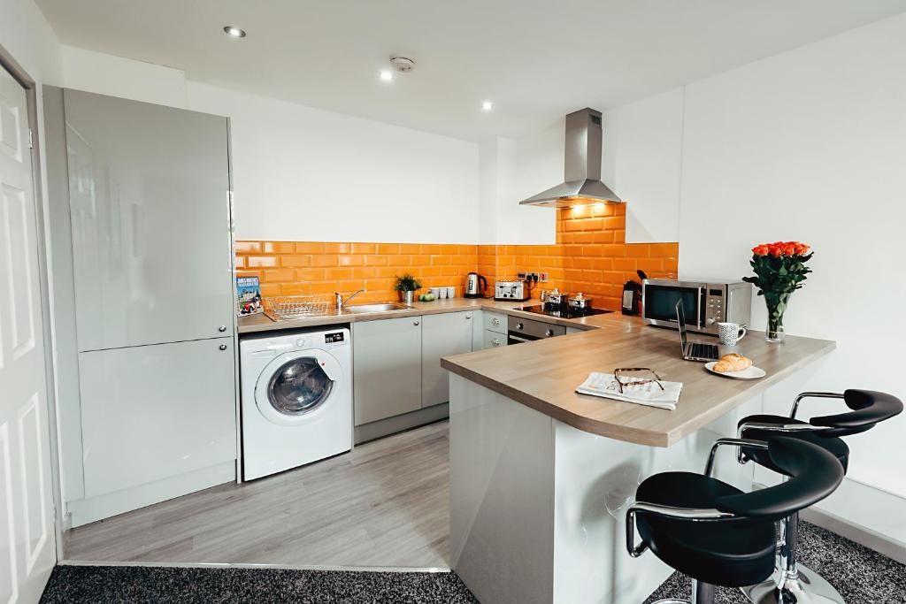 a kitchen with a counter and a washer and dryer at Halifax House, One Bedroom Apartment 216 in Halifax