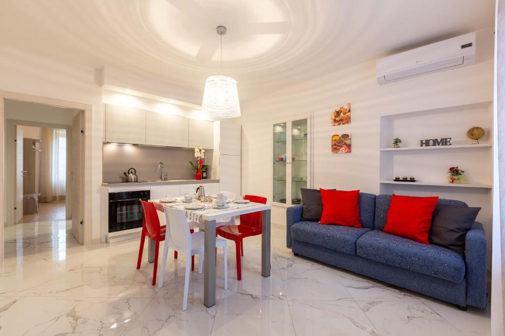 a living room with a table and a blue couch at Residenza San Rocco in Arco
