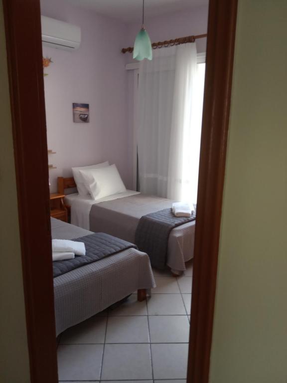 Postel nebo postele na pokoji v ubytování Filippos House