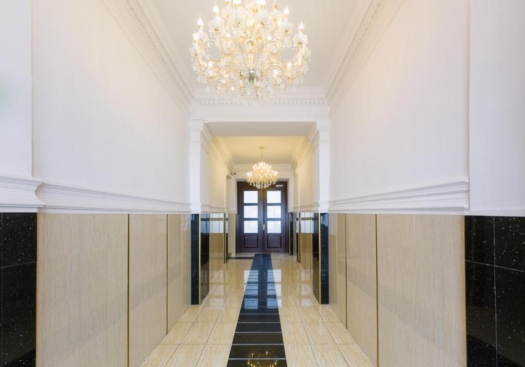 a hallway of a building with a chandelier at Waldmüller Apartments Vienna in Vienna