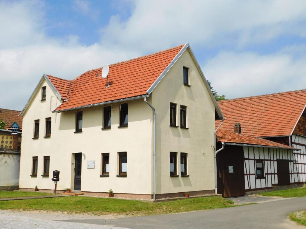 a large white building with an orange roof at Ferienwohnungen Landleben in Kammerforst