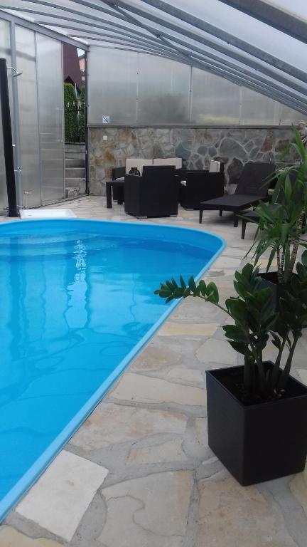 a large swimming pool in a house with a patio at Apartmán Ústie in Trstená