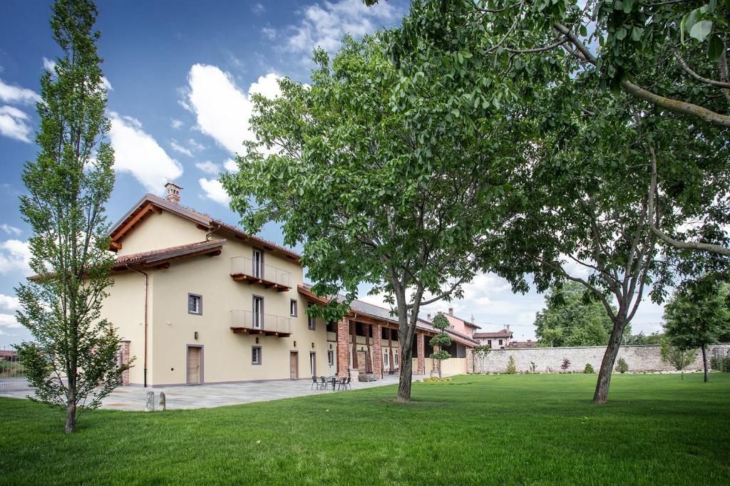 a house with a tree in front of it at Agr. Cascina Fabbrica in Fossano
