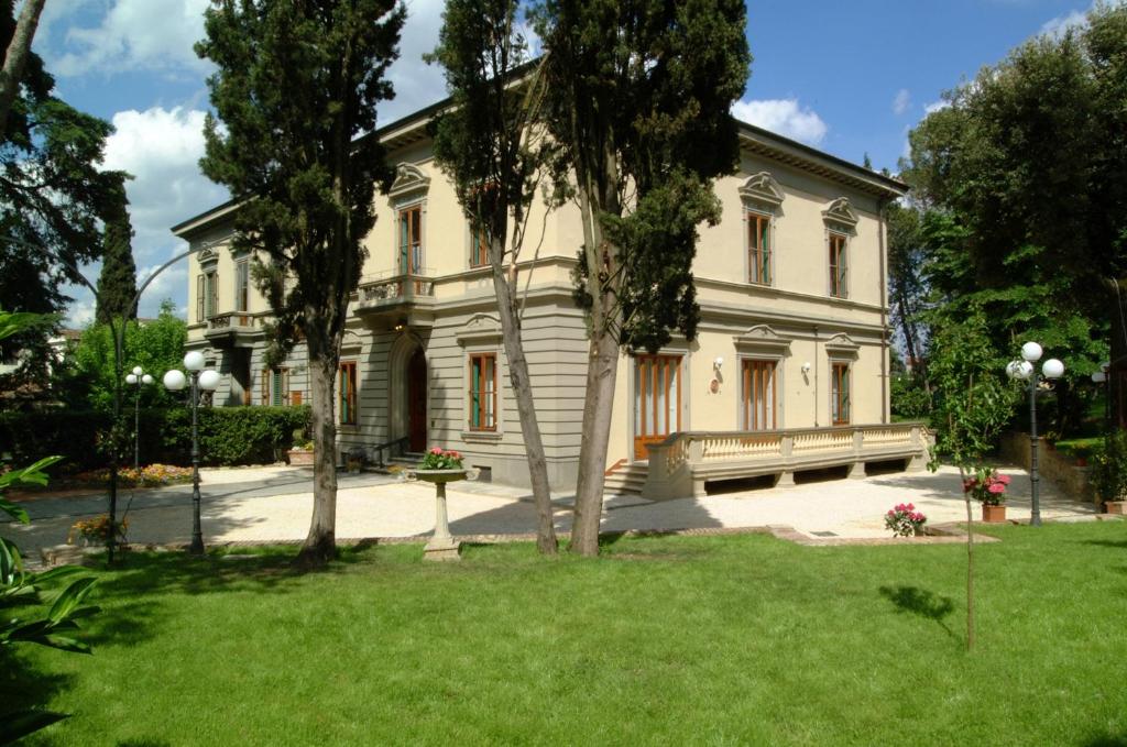 a large house with a yard in front of it at Residence Michelangiolo in Florence
