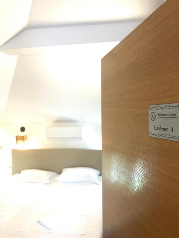 Postel nebo postele na pokoji v ubytování Residence Mahala