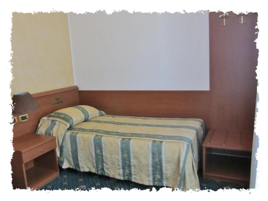 Postel nebo postele na pokoji v ubytování Hotel Green castellani