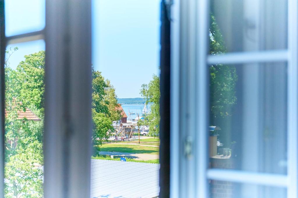 a view from a window looking out at a park at Hotel Garni Goldammer in Dießen am Ammersee