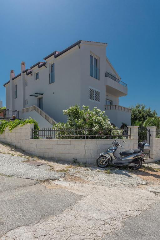 a motorcycle parked in front of a building at Hvar Top View Apartments in Hvar