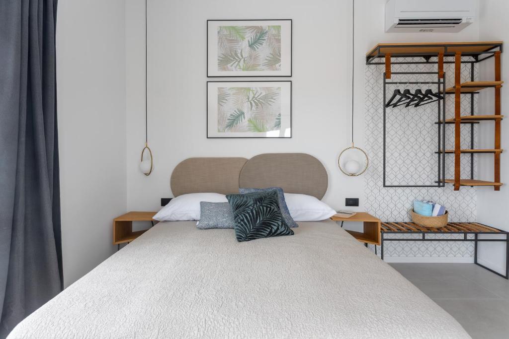 a bedroom with a large bed with two pillows on it at Hvar Top View Apartments in Hvar