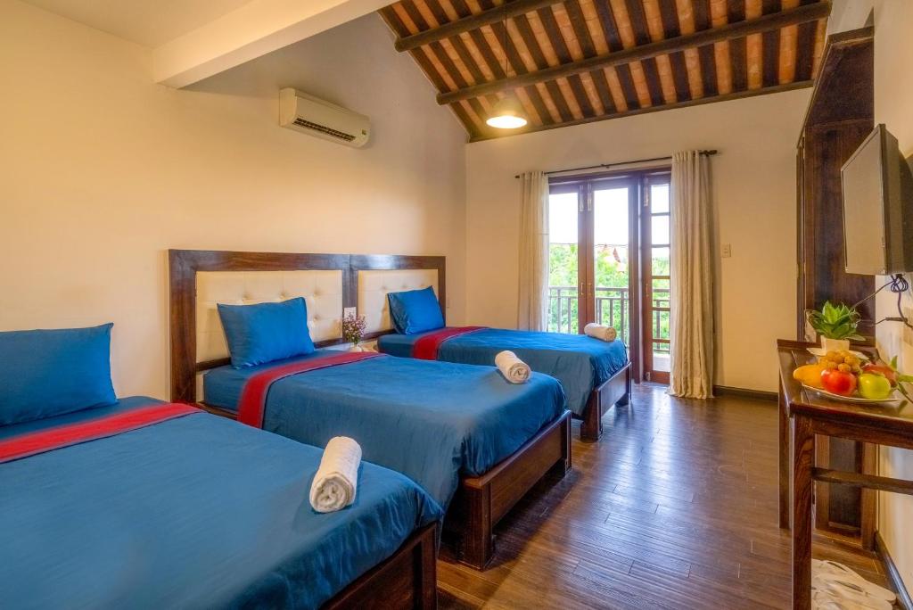 Llit o llits en una habitació de Calm House Hotel Hoi An 1