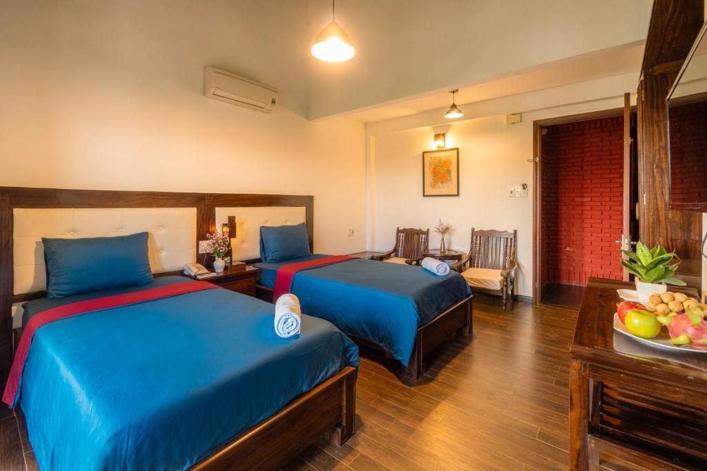 Llit o llits en una habitació de Calm House Hotel Hoi An 1