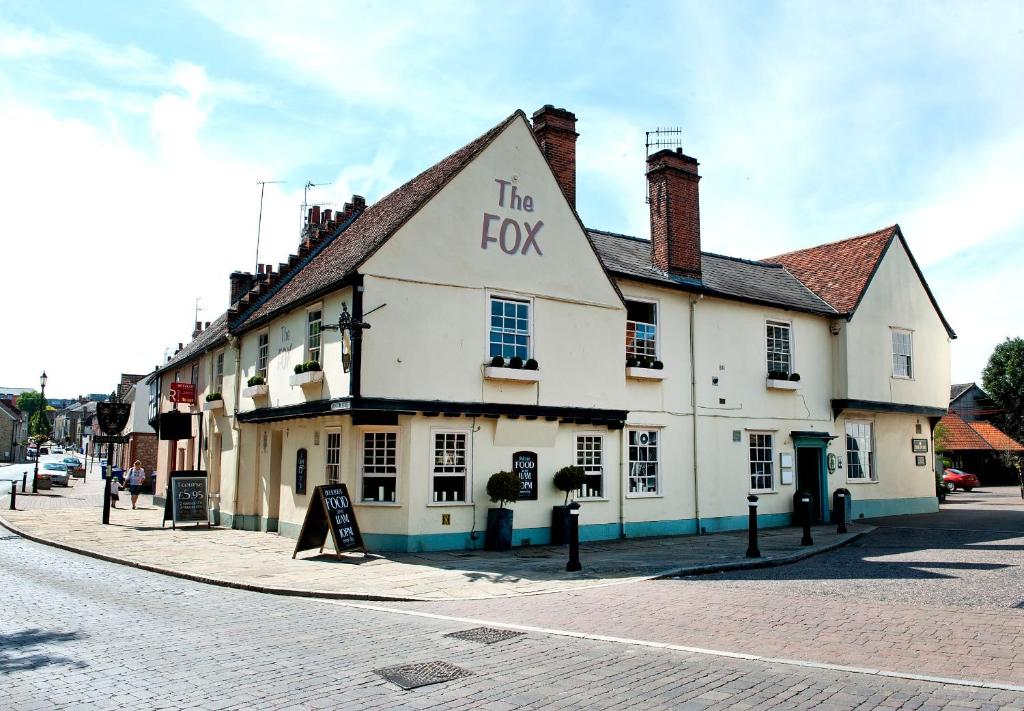 a building with the fox written on it on a street at The Fox by Greene King Inns in Bury Saint Edmunds