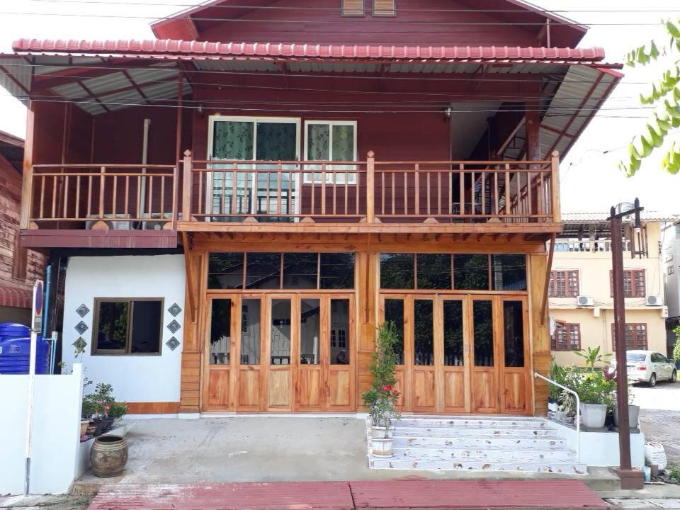 a house with a balcony on top of it at Baan Kokaew Chiang Khan in Chiang Khan