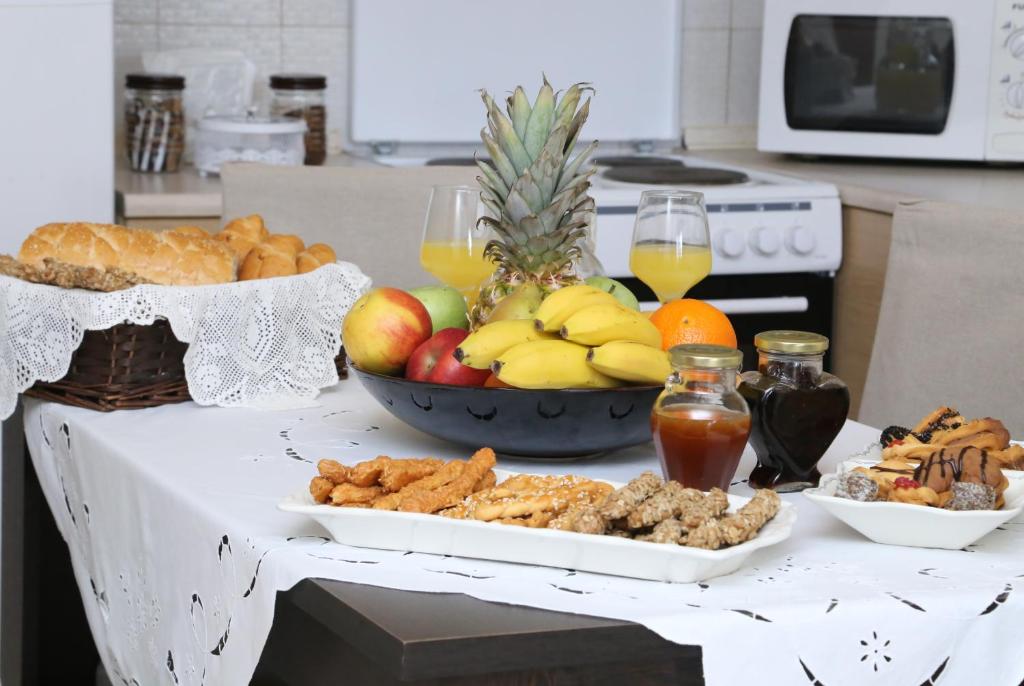 a table full of food and fruit on a counter at Stasa Luxury Apartments in Keramoti