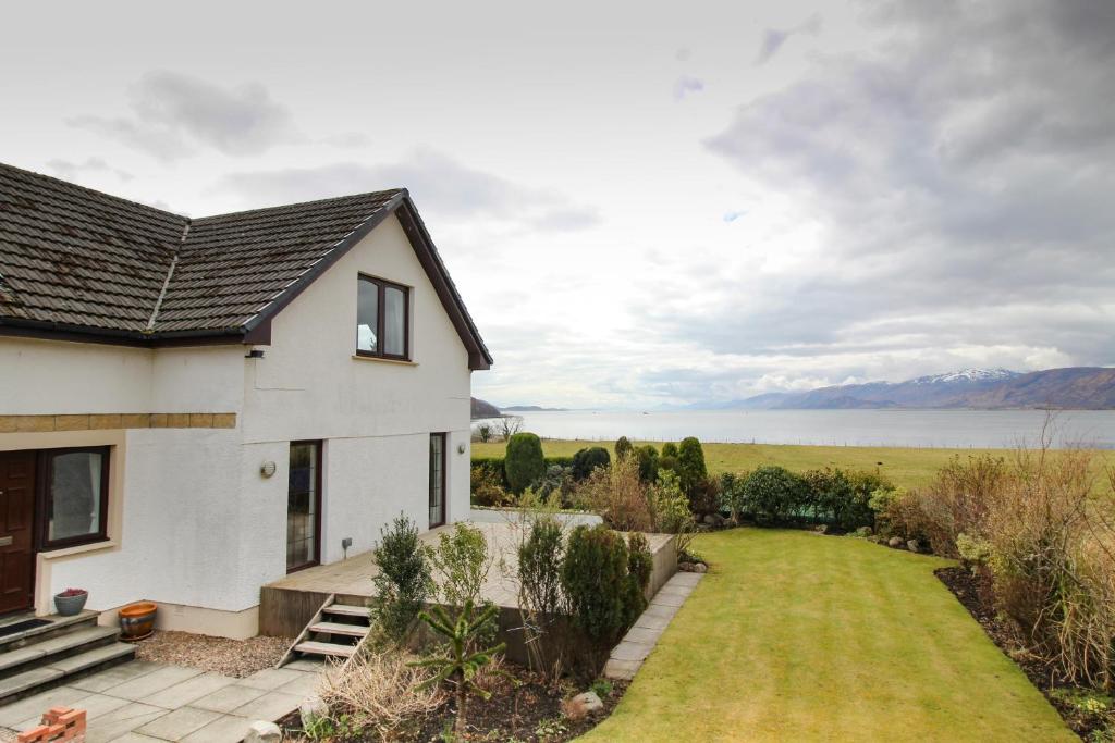 a house with a view of the water at Lochview Guesthouse in Corran