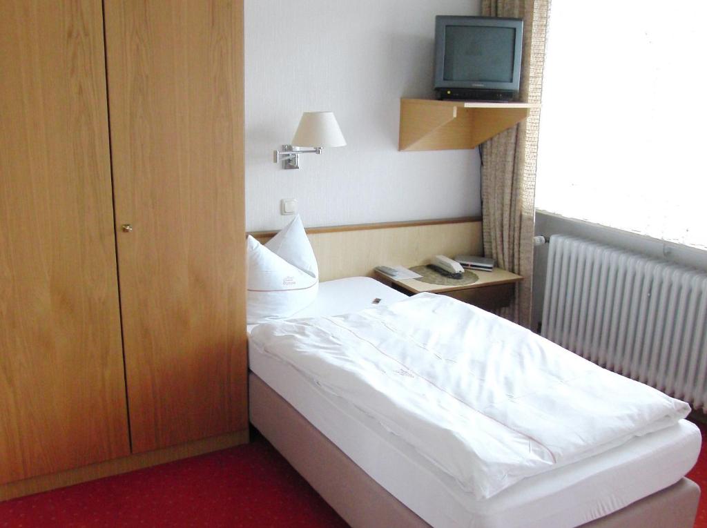 Postel nebo postele na pokoji v ubytování Hotel Olympia