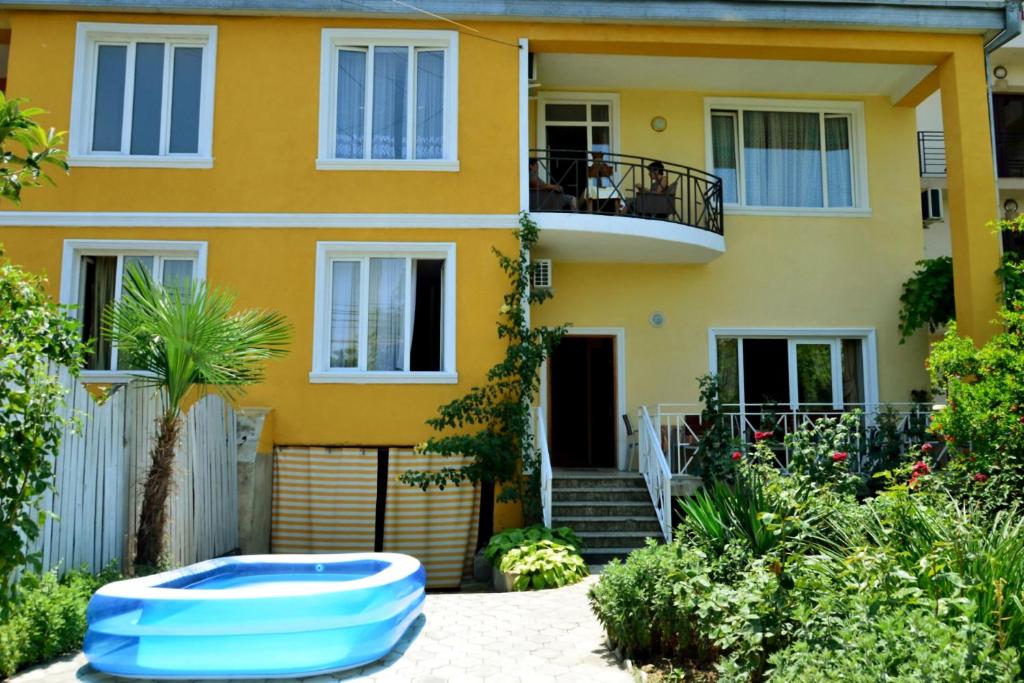 a house with a blue boogie board in front of it at Boutique Hotel Eco-House Tbilisi in Tbilisi City