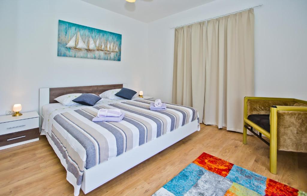 a bedroom with a large bed and a chair at Sweet Dreams in Hvar