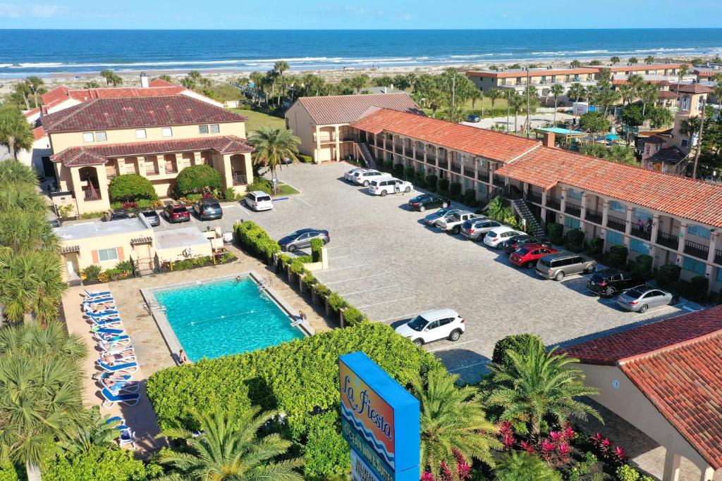 an aerial view of a hotel with a parking lot and the ocean at La Fiesta Ocean Inn & Suites in Saint Augustine Beach