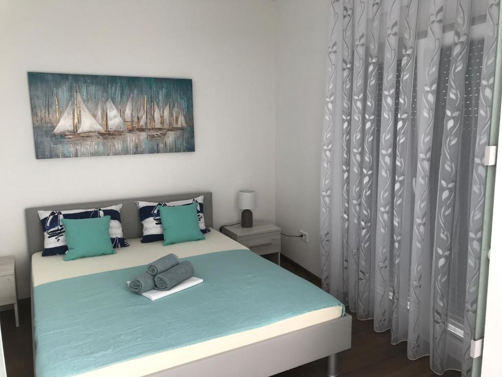 Postel nebo postele na pokoji v ubytování Apartmani Anloma Lorainne