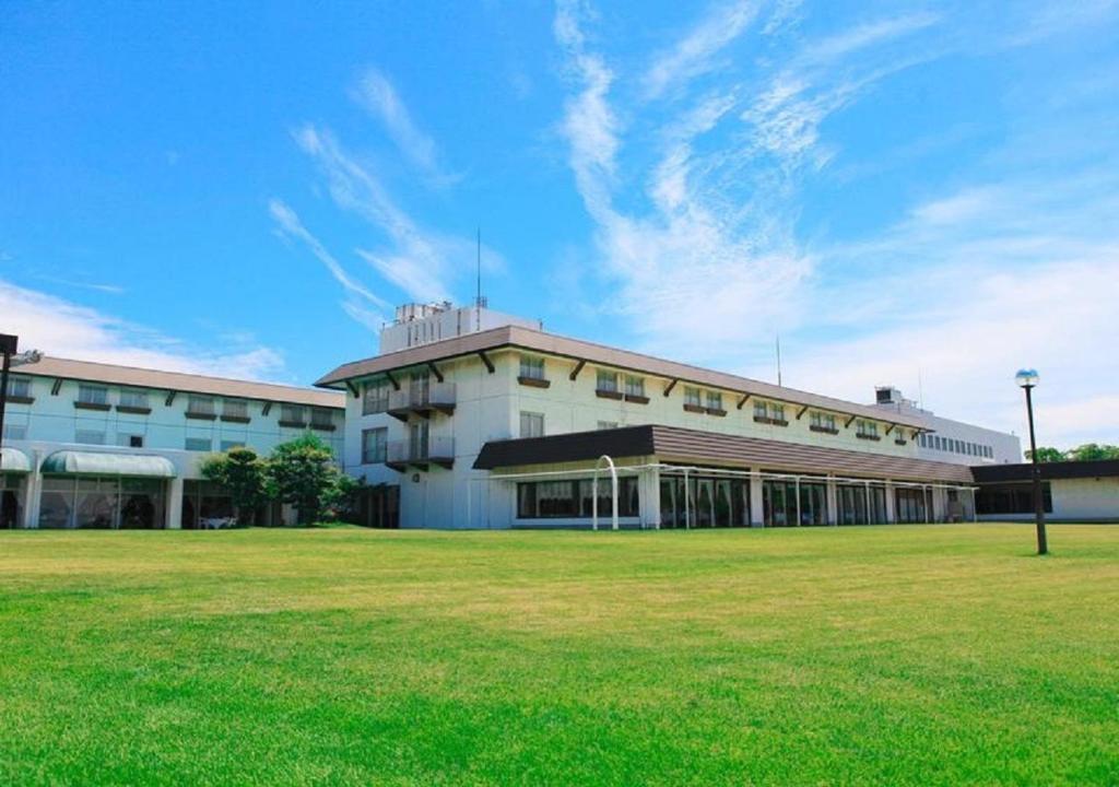 a large building with a grass field in front of it at Kurashiki - Hotel / Vacation STAY 31267 in Kurashiki