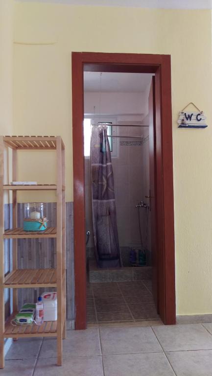 a bathroom with a shower in a room at Dimitris & Vassiliki's apartment in Possidi