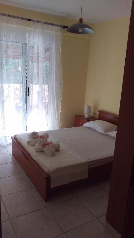a bedroom with a large bed with towels on it at Dimitris & Vassiliki's apartment in Possidi