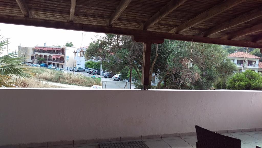 a balcony with a view of a street with cars at Dimitris & Vassiliki's apartment in Possidi