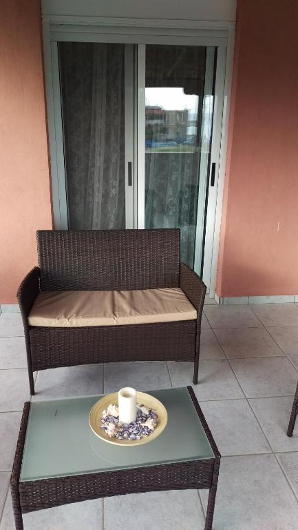 a table with a plate with a candle on a couch at Dimitris & Vassiliki's apartment in Possidi