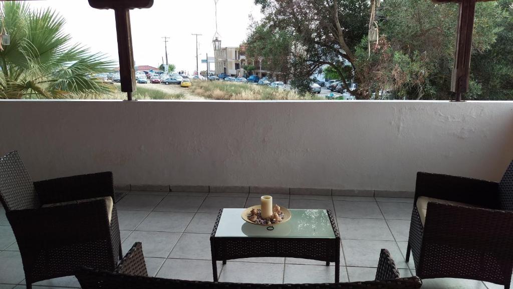 a candle sitting on a table on a patio at Dimitris & Vassiliki's apartment in Possidi
