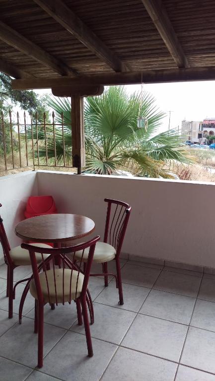 a table and chairs on a porch with a table at Dimitris & Vassiliki's apartment in Possidi