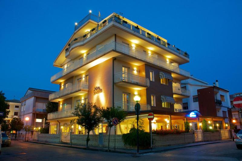 a large white building with lights on top of it at Hotel Jollino in Pineto