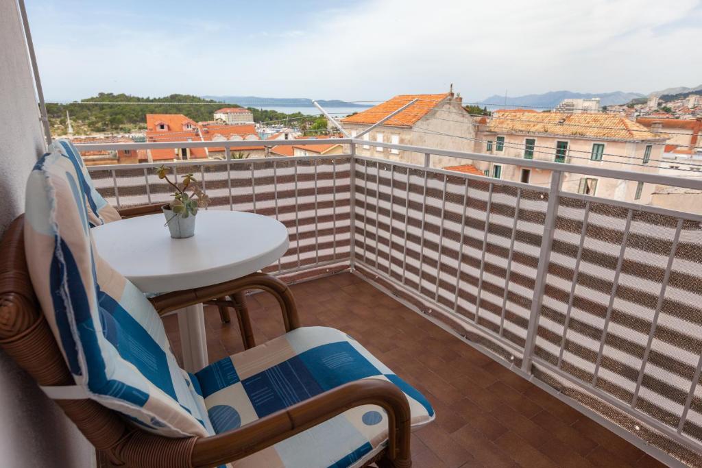a balcony with a table and chairs and a view at Guest House Town Center in Makarska