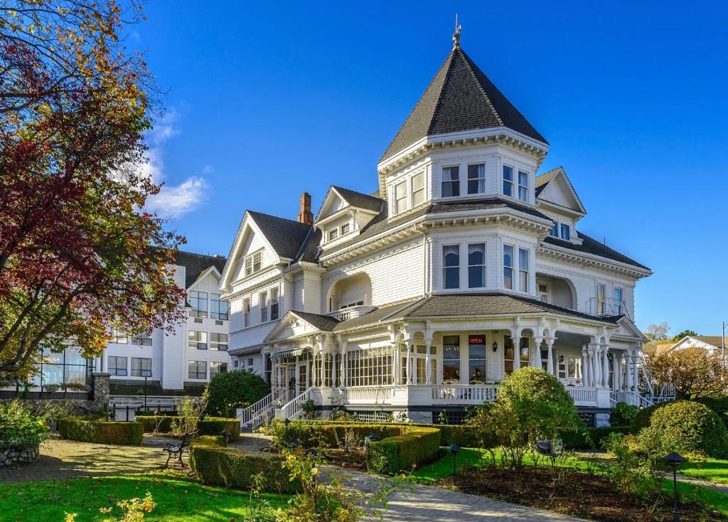 a large white house with a turret at Pendray Inn and Tea House in Victoria