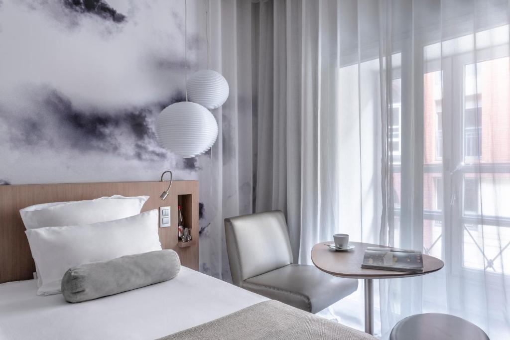 Postel nebo postele na pokoji v ubytování Le Grand Balcon Hotel