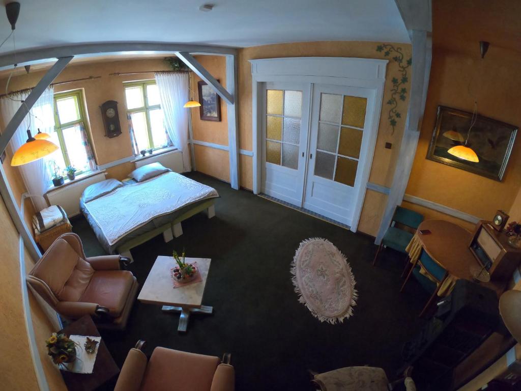 an overhead view of a room with a bed and chairs at Apartament w Kamienicy in Biskupiec