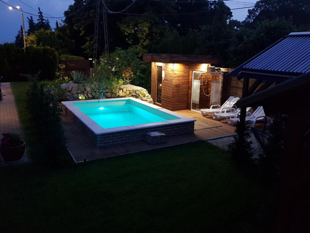 ein Schwimmbad in der Mitte eines Gartens in der Unterkunft Sunrise Apartmanház in Balatonfüred