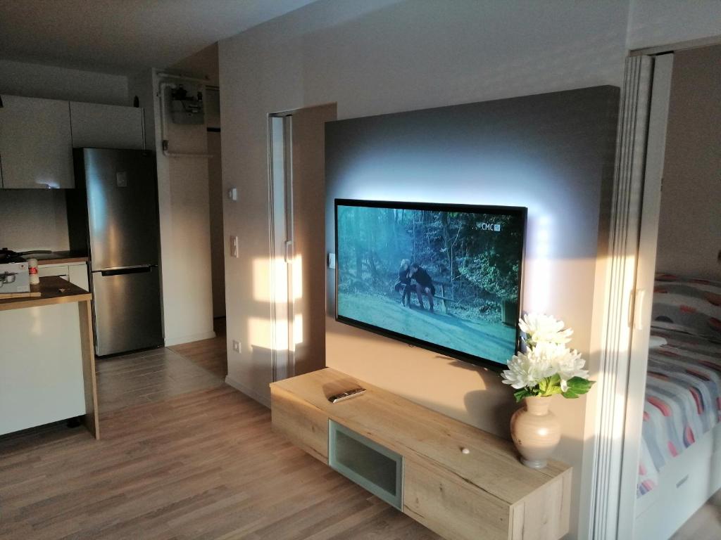 a living room with a flat screen tv on a wall at Portus in Zagreb