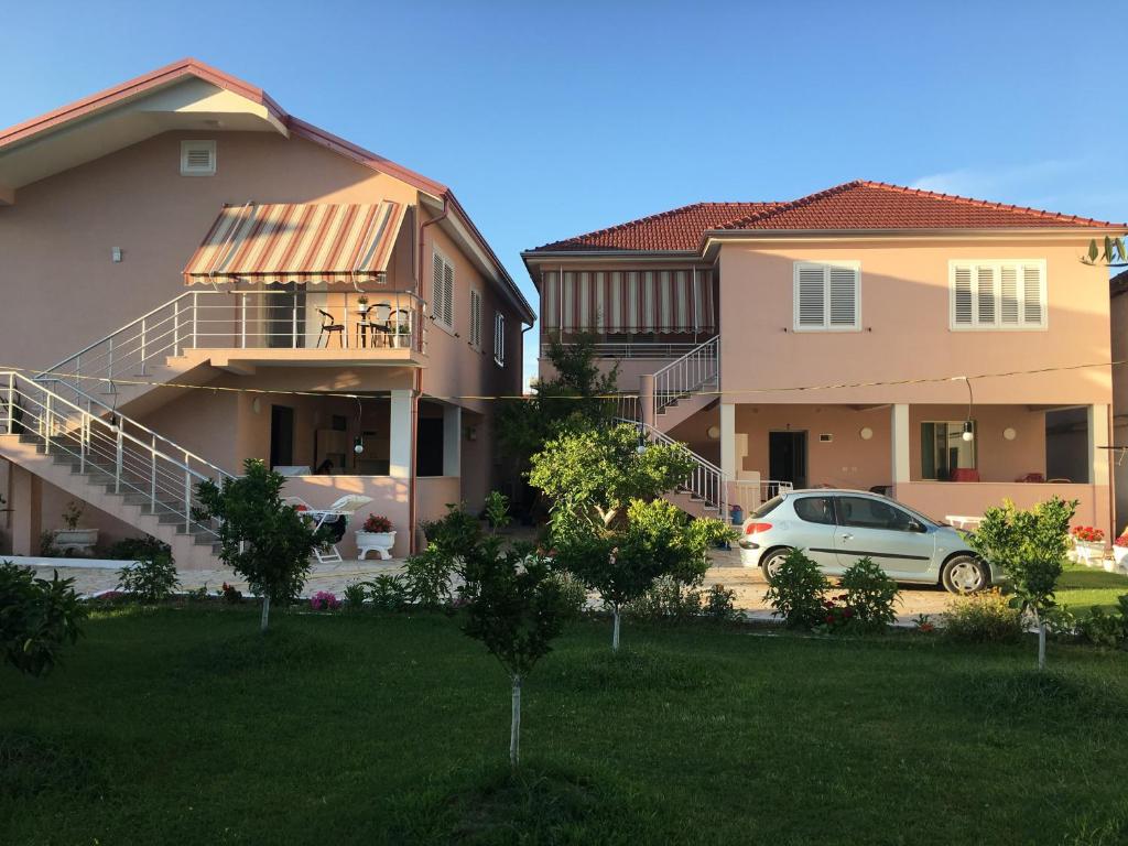 a car parked in front of two houses at Vila Islami in Durrës
