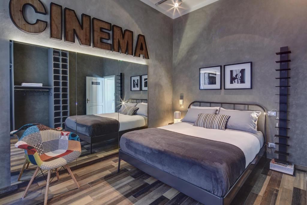 a bedroom with two beds and a sign that reads cinema at Urban 3 in Arezzo