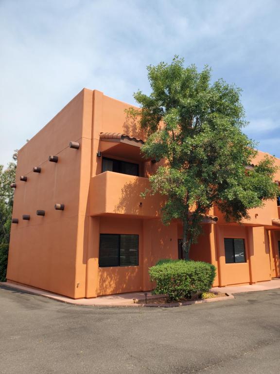 a orange building with a tree in front of it at Red Rock Luxury in Sedona