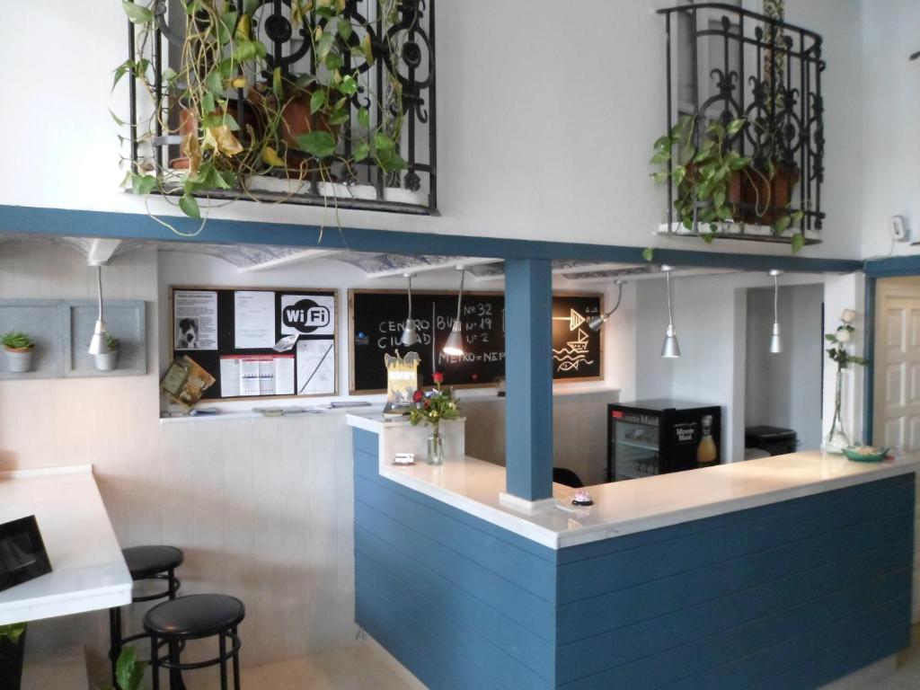 a restaurant with a blue counter with stools at Hostal La Barraca in Valencia